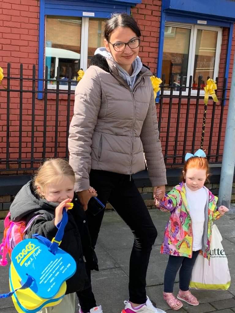 Mirabela with two children off to swim classes 