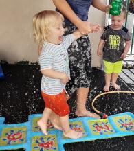 Walking on the splash mat in our shaded back yard 